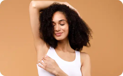 Woman who does not struggle with sweat or odor lifting her arms