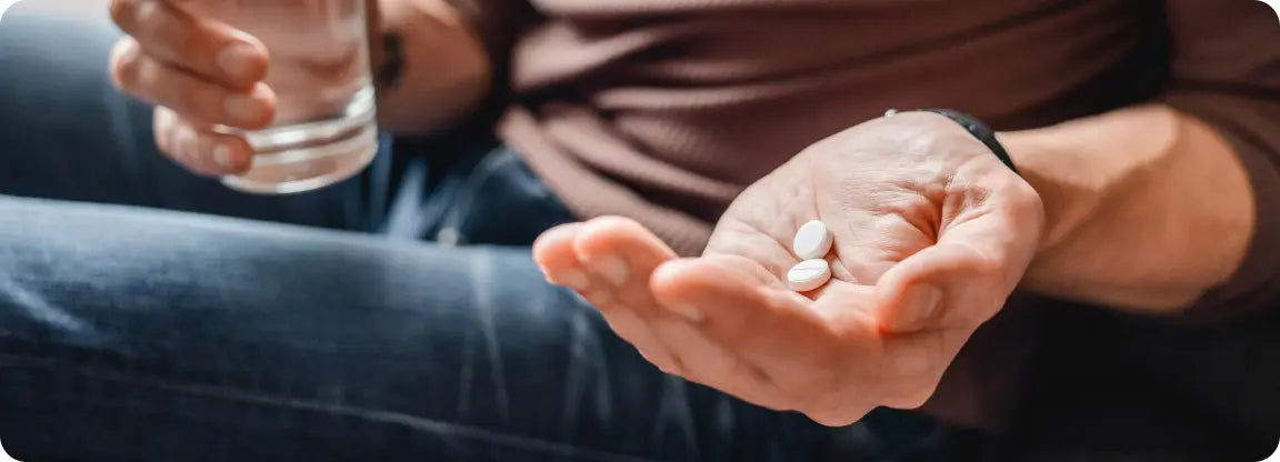 person holding glycopyrrolate tablets