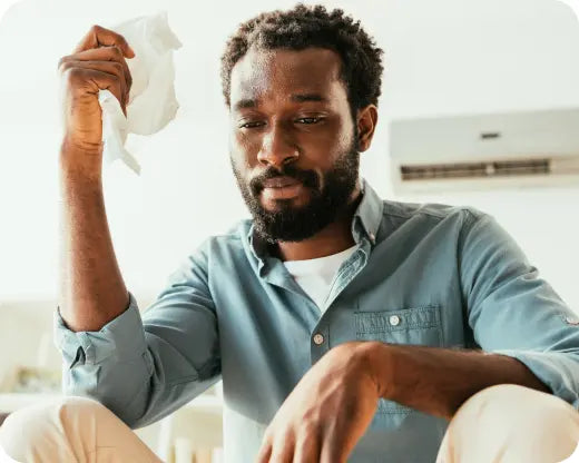 Man wiping hands because he has palmar hyperhidrosis